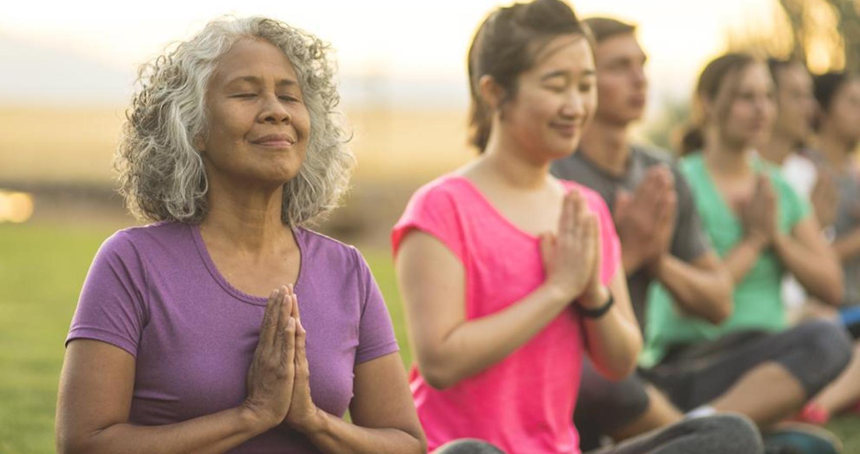 Older adults doing yoga outside